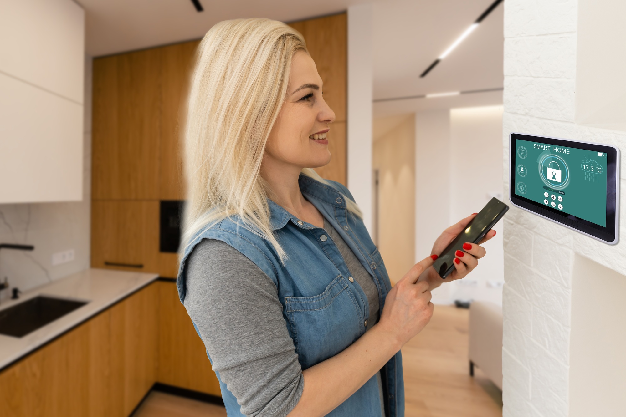 pretty blonde woman using smart home control panel.