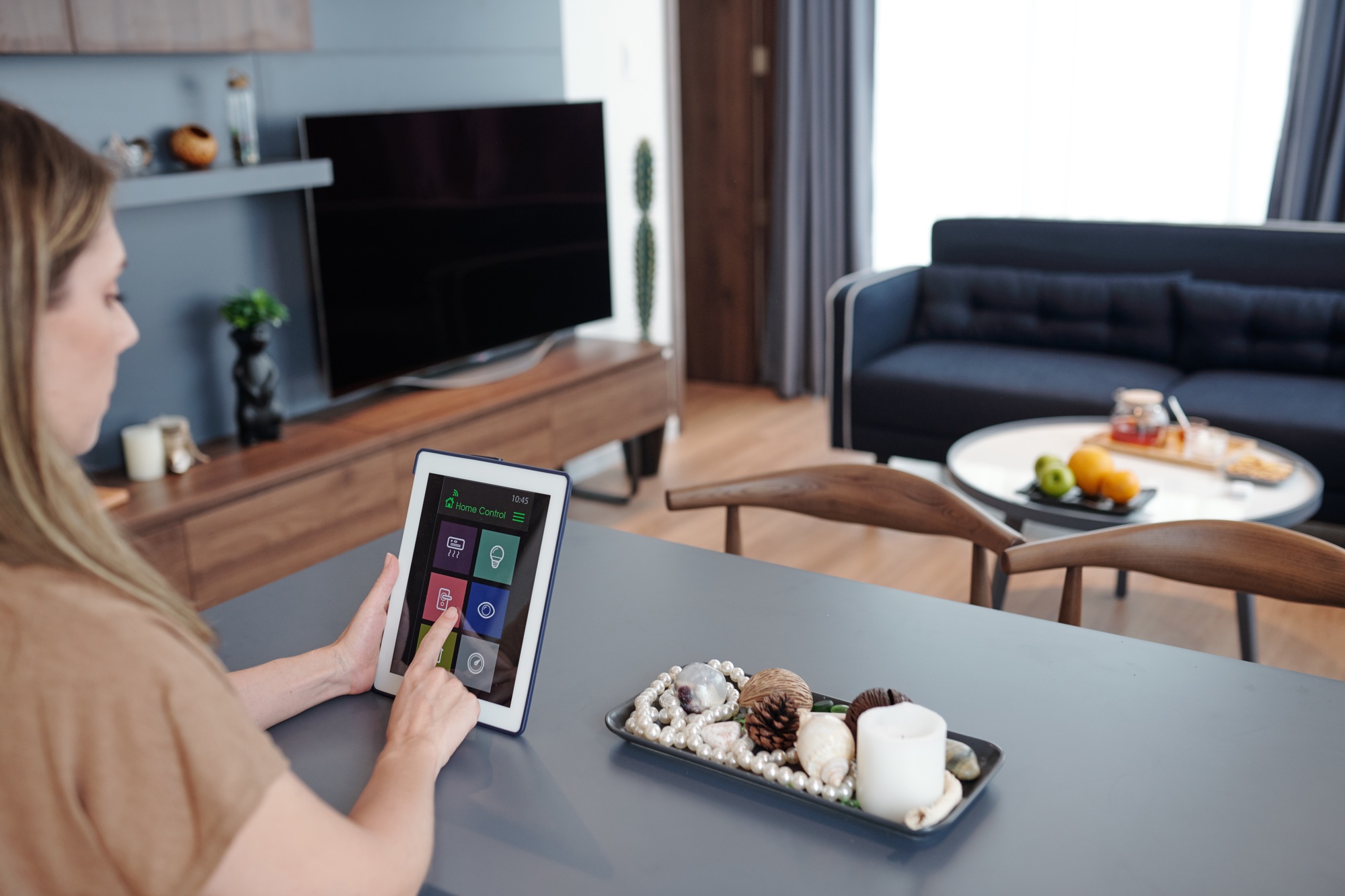 Woman using home control app